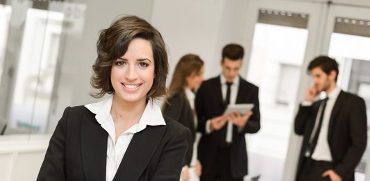 Image of businesswoman leader looking at camera in working environment