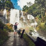 Traveler near waterfall