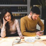 Young couple at the bar. Concept of betrayal.