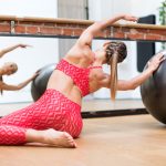 Young woman doing pilates mermaid exercises