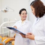 Dentist talking to nurse