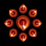 Happy Diwali. Diya oil lamps against dark background,