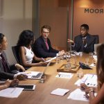 Businessman addressing corporate colleagues at a meeting