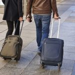 Young couple with baggage on the street. Travel and tourism