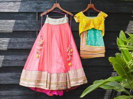 Traditional Indian saree (sari) wedding dress for indian bride and blouse hanging on the wood wall