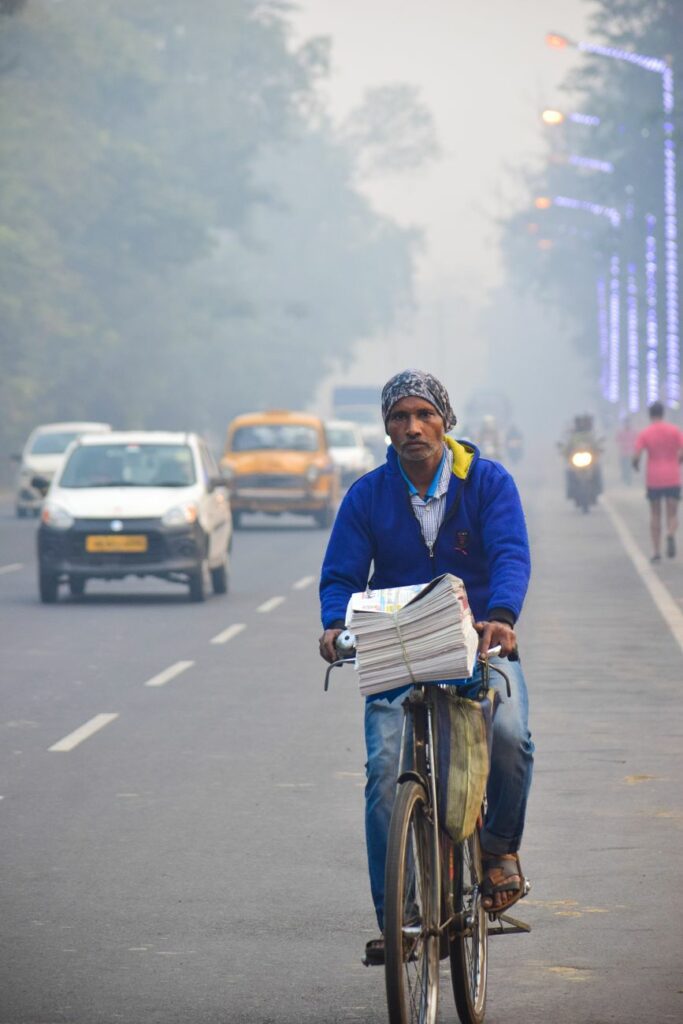 man riding on a bike on a street in india