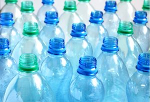 Many empty blue and green water bottles. Shallow DOF.