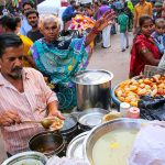 Local man selling food at Kinari Bazaar in Agra, Uttar Pradesh,