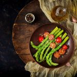 Vegan warm salad of roasted asparagus and tomatoes.