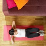 Woman Doing Abs Abdominals Exercise On Pad At Home