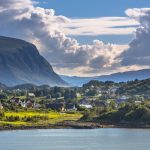 Norwegian village in fjord landscape on sunny day