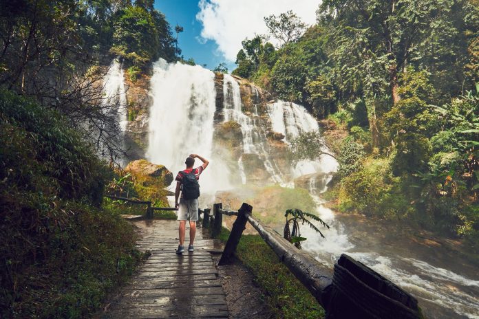 Traveler near waterfall