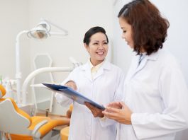 Dentist talking to nurse