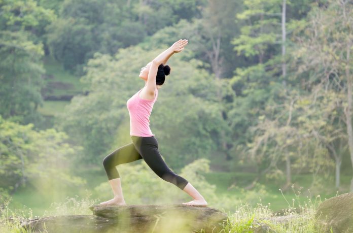 young beautiful asian woman practicing yoga