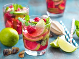 Refreshing mint cocktail mojito with rum, lime and raspberry, cold drink or beverage