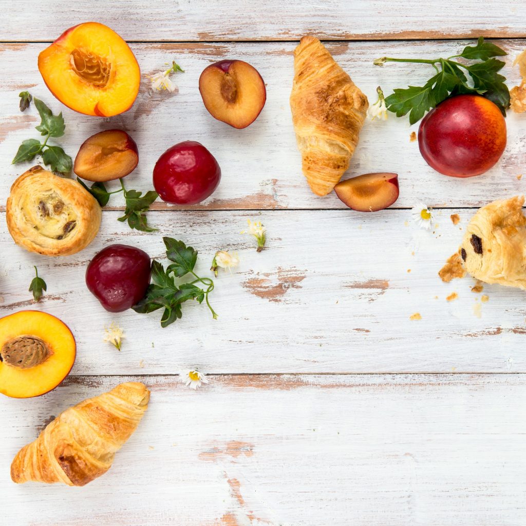 Spring or Summer Concept with Peaches, Plums, Grapes and Pastries