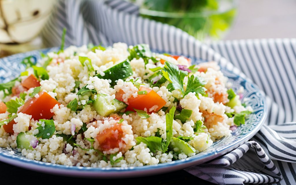 Traditional Lebanese Salad Tabbouleh. Couscous with parsley, tomato, cucumber, lemon
