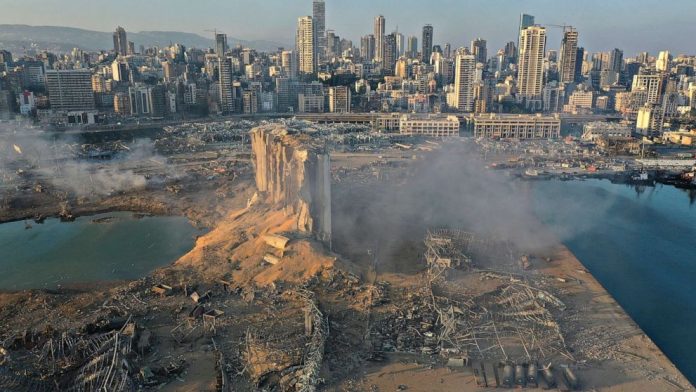 The image portrays the state of Beirut after the Explosion. The area around the port is flattened and ruined.