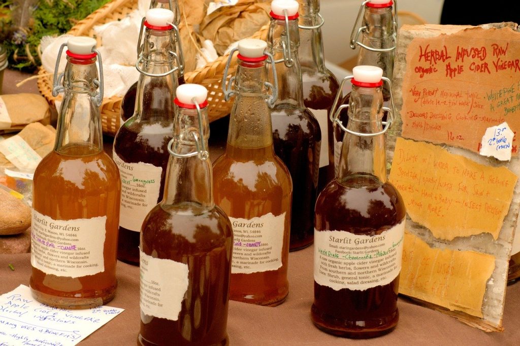 apples cider vinegar in different glass bottles