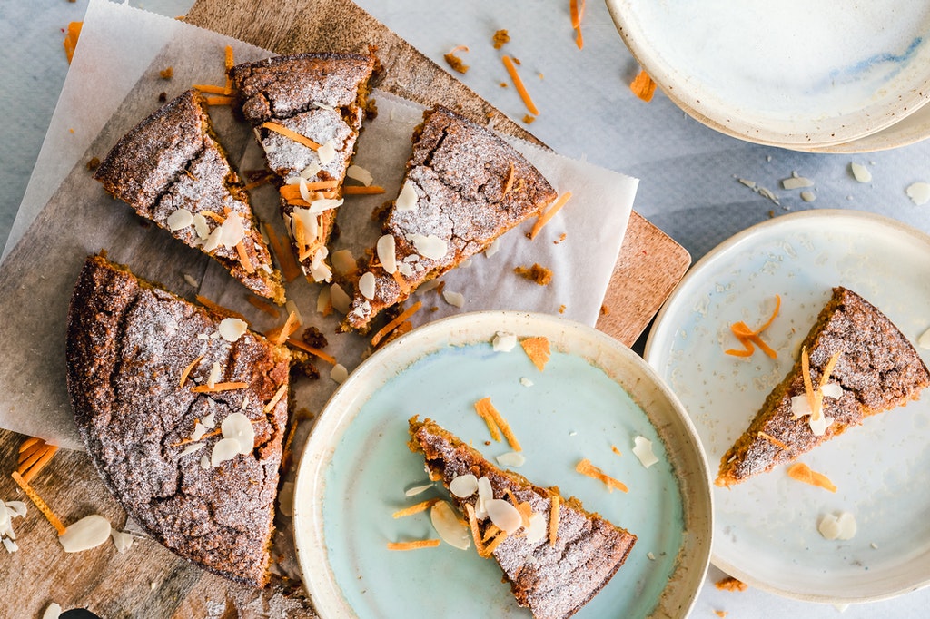 Freshly baked banana chocolate cake   garnished with powdered sugar and grated carrots