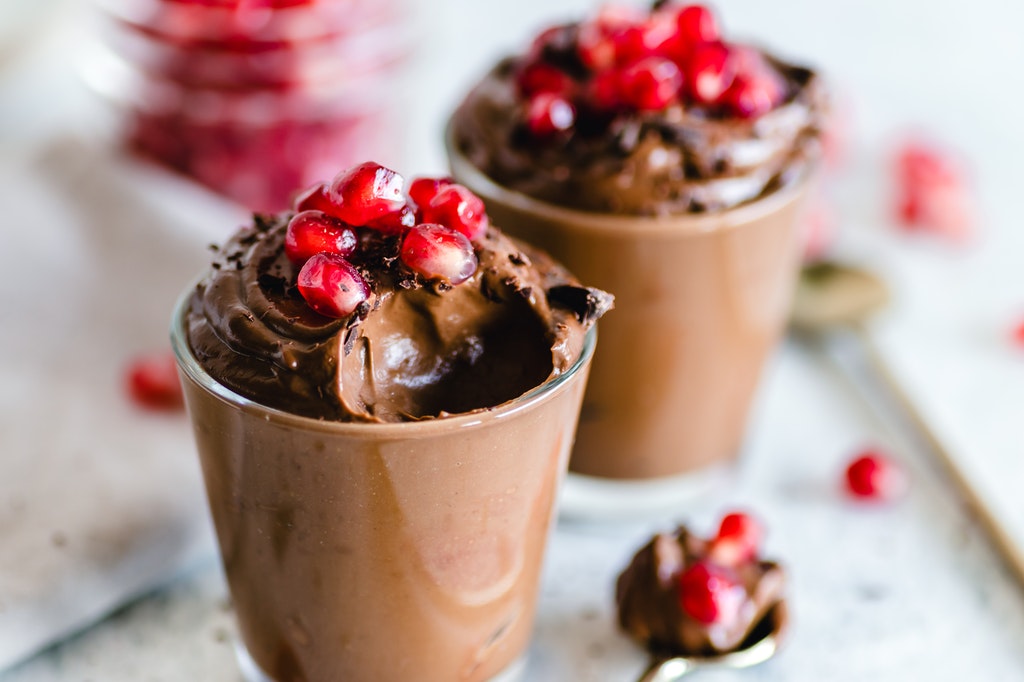 Oreo flavored chocolate mousse garnishes with pomegranate seeds.