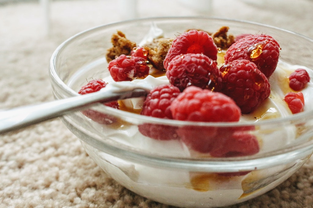 A bowl of yogurt with cranberries