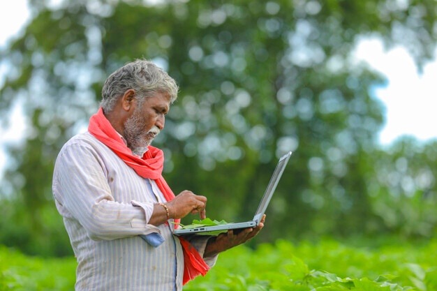 indian farmer using laptop agriculture field 54391 2217