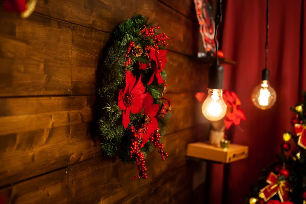 Christmas living room with beautiful christmas wreath on the wall