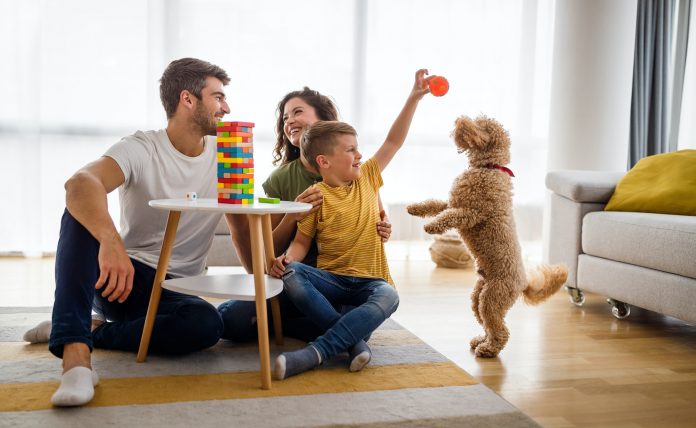 Happy family having fun, playing board game at home