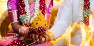 Indian Hindu Traditional Wedding Ceremony - Close up shot of the couple hand holding the decorative