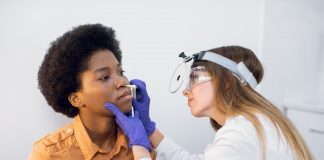 Young afro american lady patient at modern ENT clinic. Professional female doctor