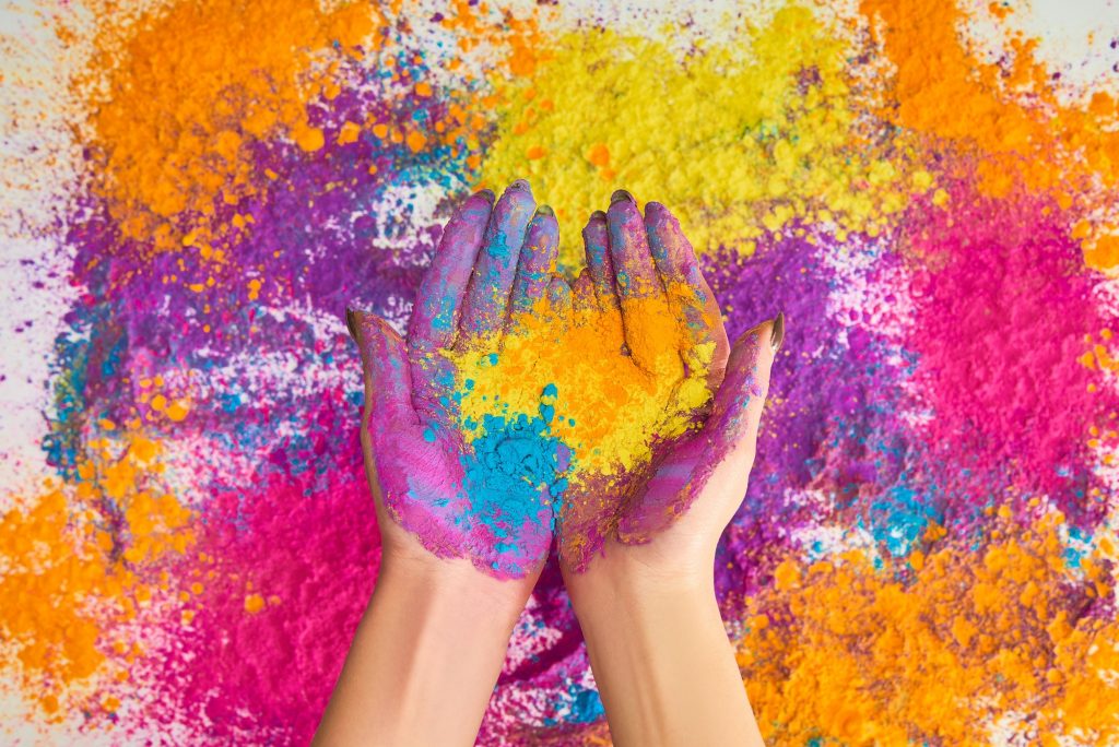 cropped view of woman holding multicolored holi powder