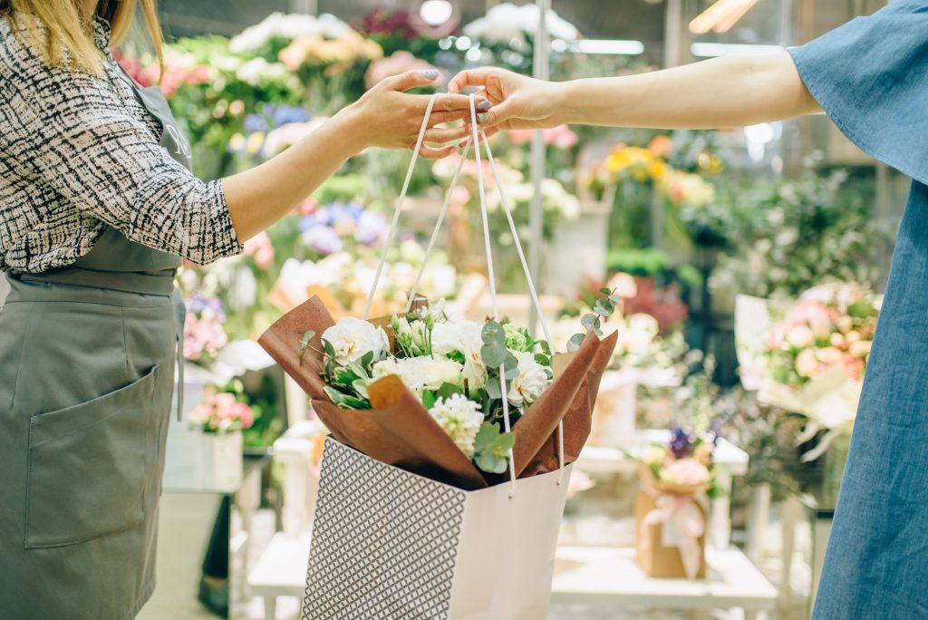 Flower shop business concept, florist and customer