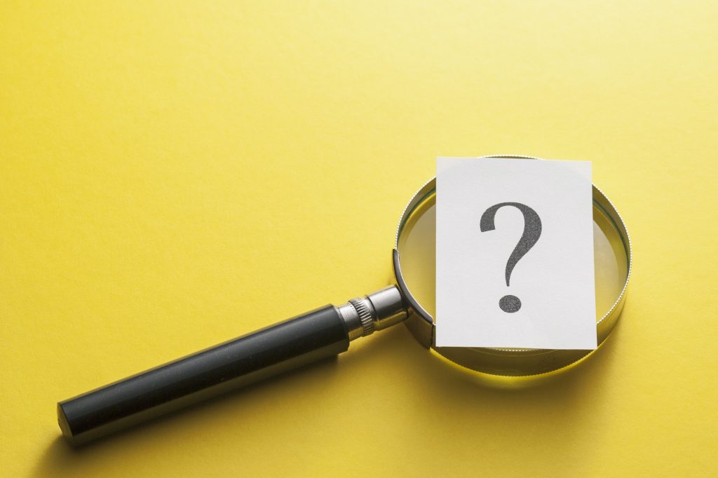 Magnifying glass with question mark on yellow