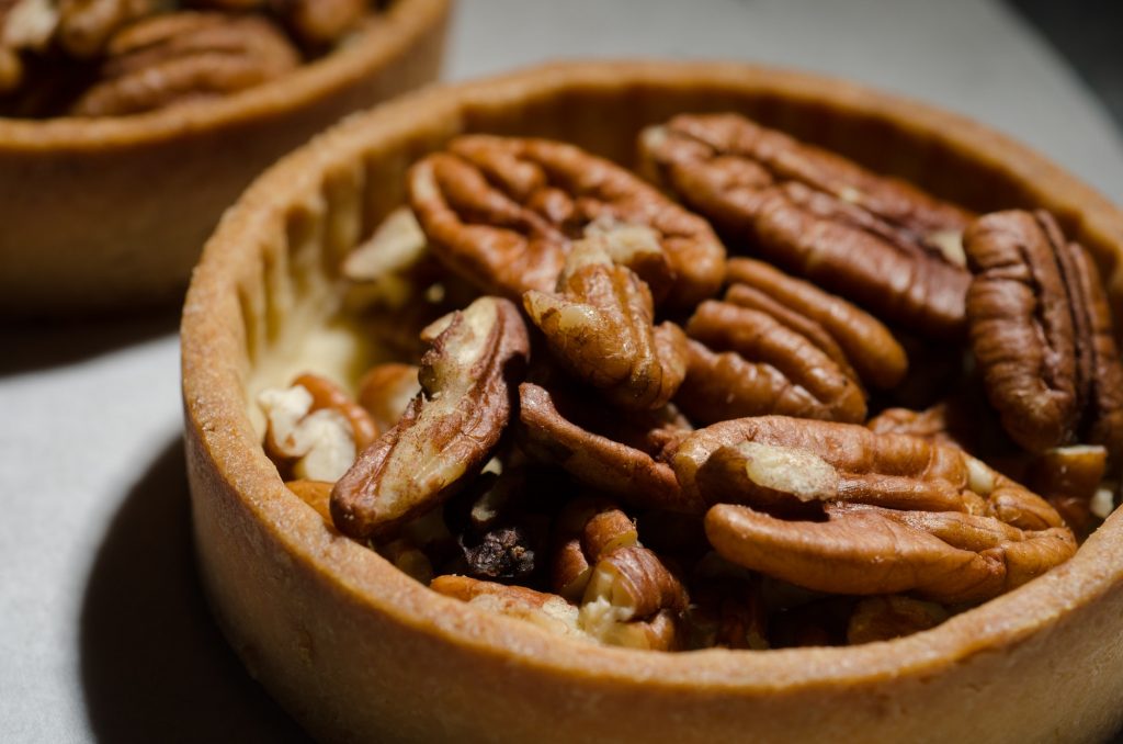 Pecan tarts ready to have batter poured into them.