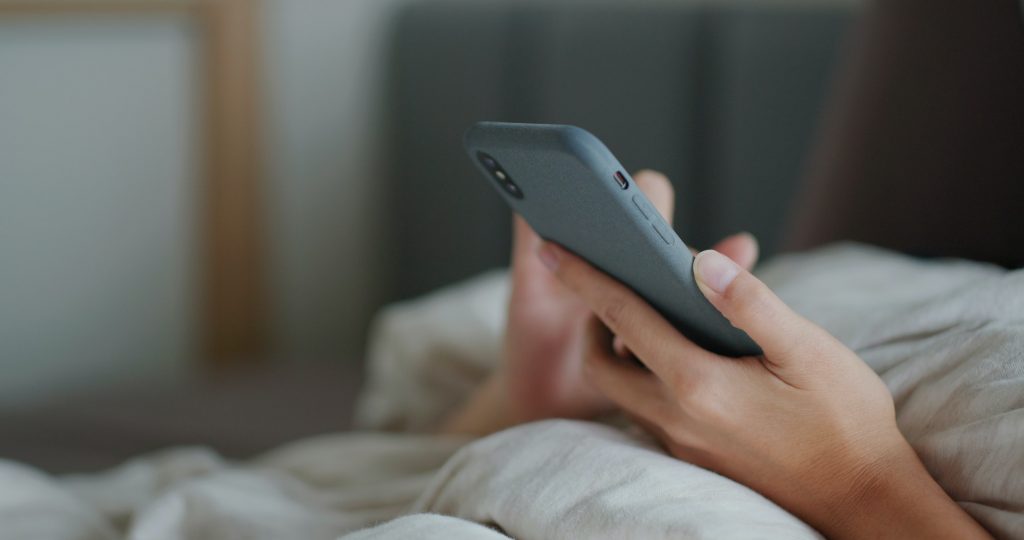 Woman use cellphone on bed
