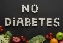 no diabetes lettering made of sugar cubes among fruits and vegetables on black