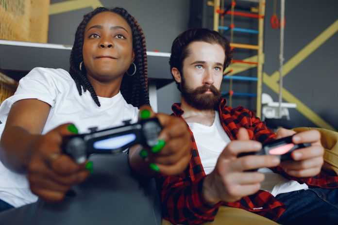 International couple playing a video games