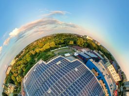 Little planet with big sustainable electric power plant with many rows of solar photovoltaic panels