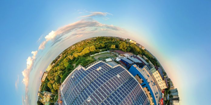 Little planet with big sustainable electric power plant with many rows of solar photovoltaic panels