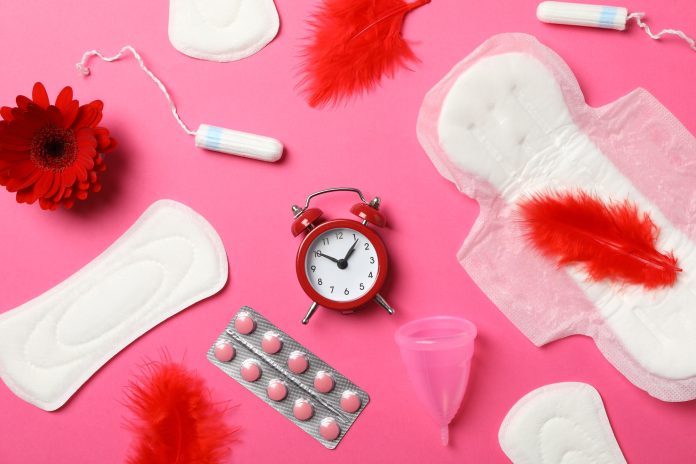 Menstrual period concept on pink background, top view