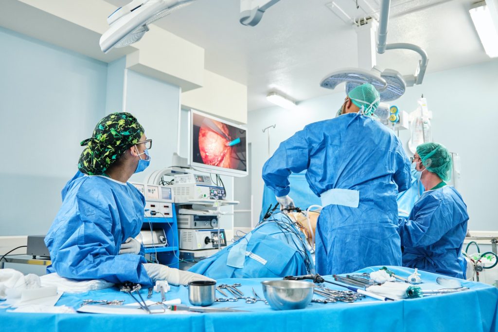 team of surgeons performing laparoscopic surgery in an operating room