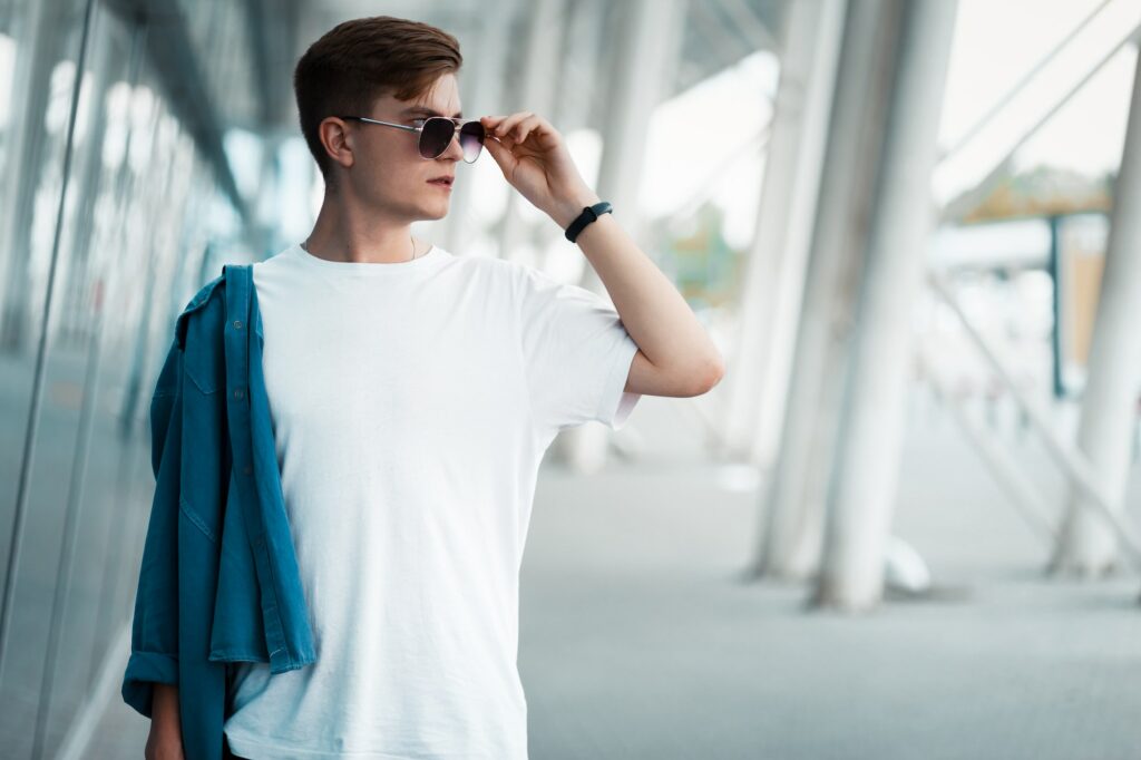 Side view of handsome confident guy in sunglasses