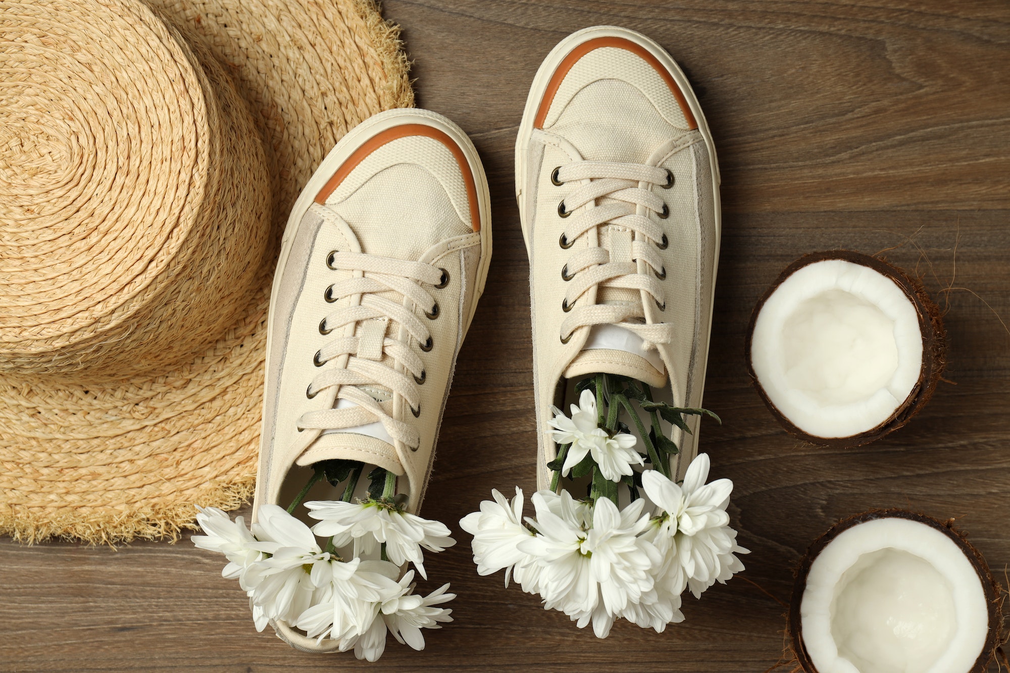 Concept of summer sneakers on wooden background