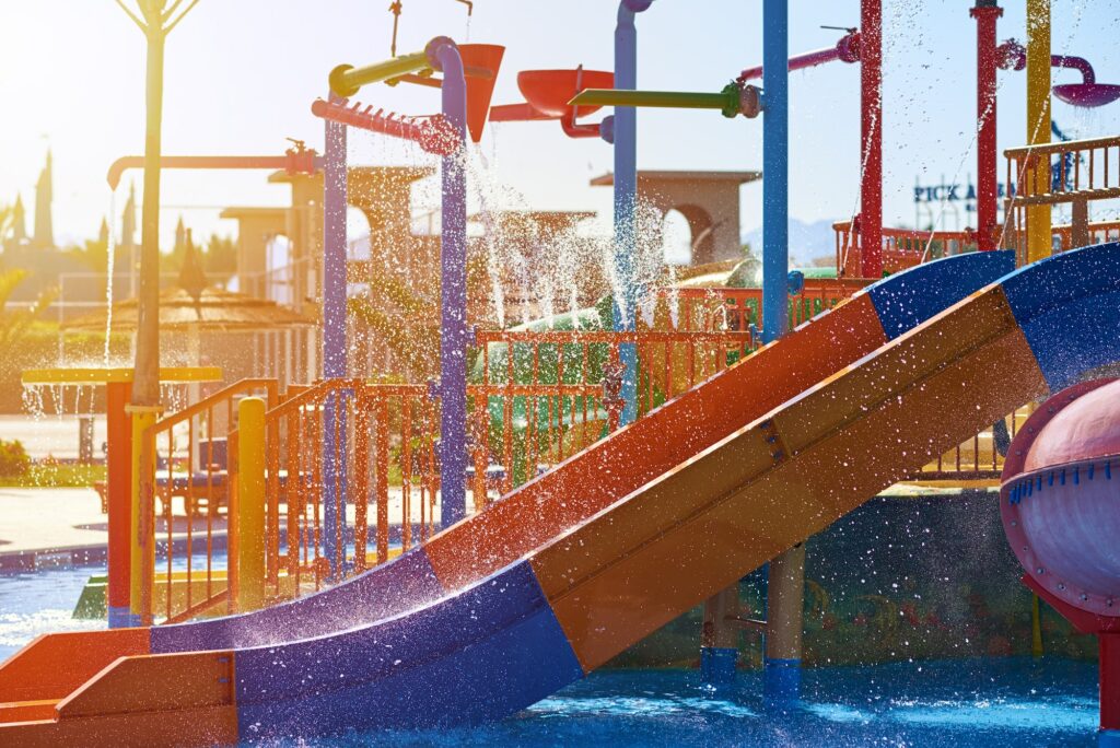 Colorful slides in the waterpark close up. Aquapark sliders with pool