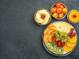 top view different fruits composition fresh and sliced fruits on a dark background fresh fruits