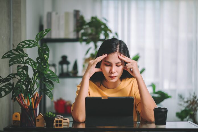 Asian woman has a headache, mental health ,Mental Health Issues