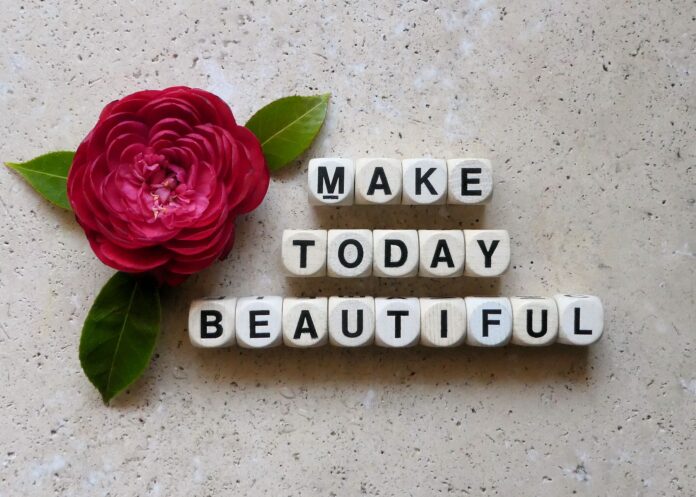 Positive quote with red flower on stone table