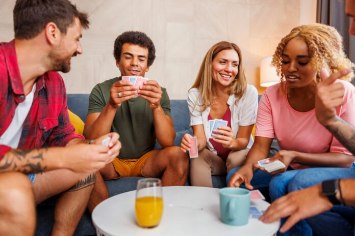 Friends having fun playing card games at home