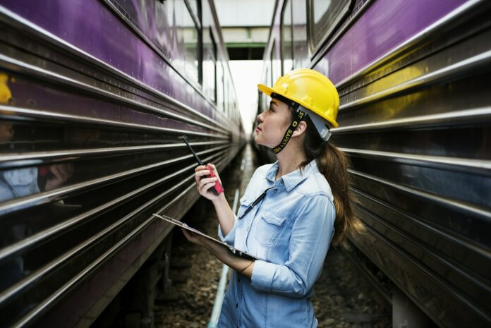 Female inspector at railroad tracks